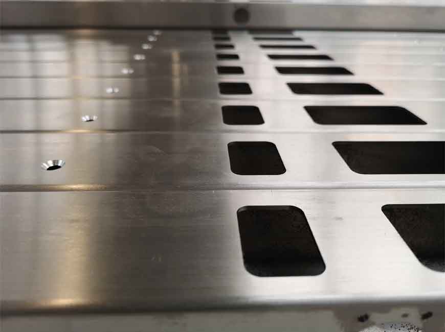Close up of precision laser cutting of stainless steel metal